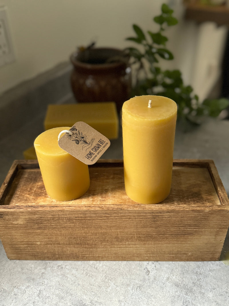 Two beeswax candles with Home Grown Bee label.