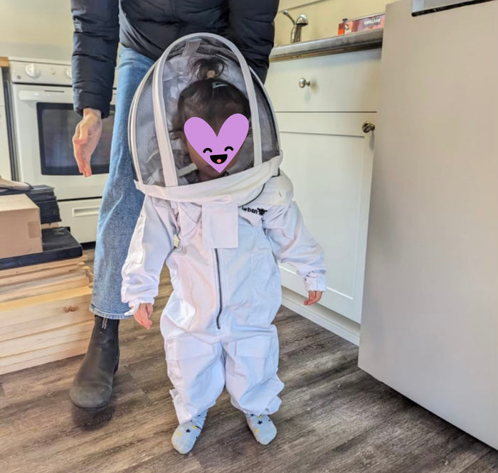 Kid in beekeeping gear at Vancouver Island Beekeeping, Home Grown Bee.